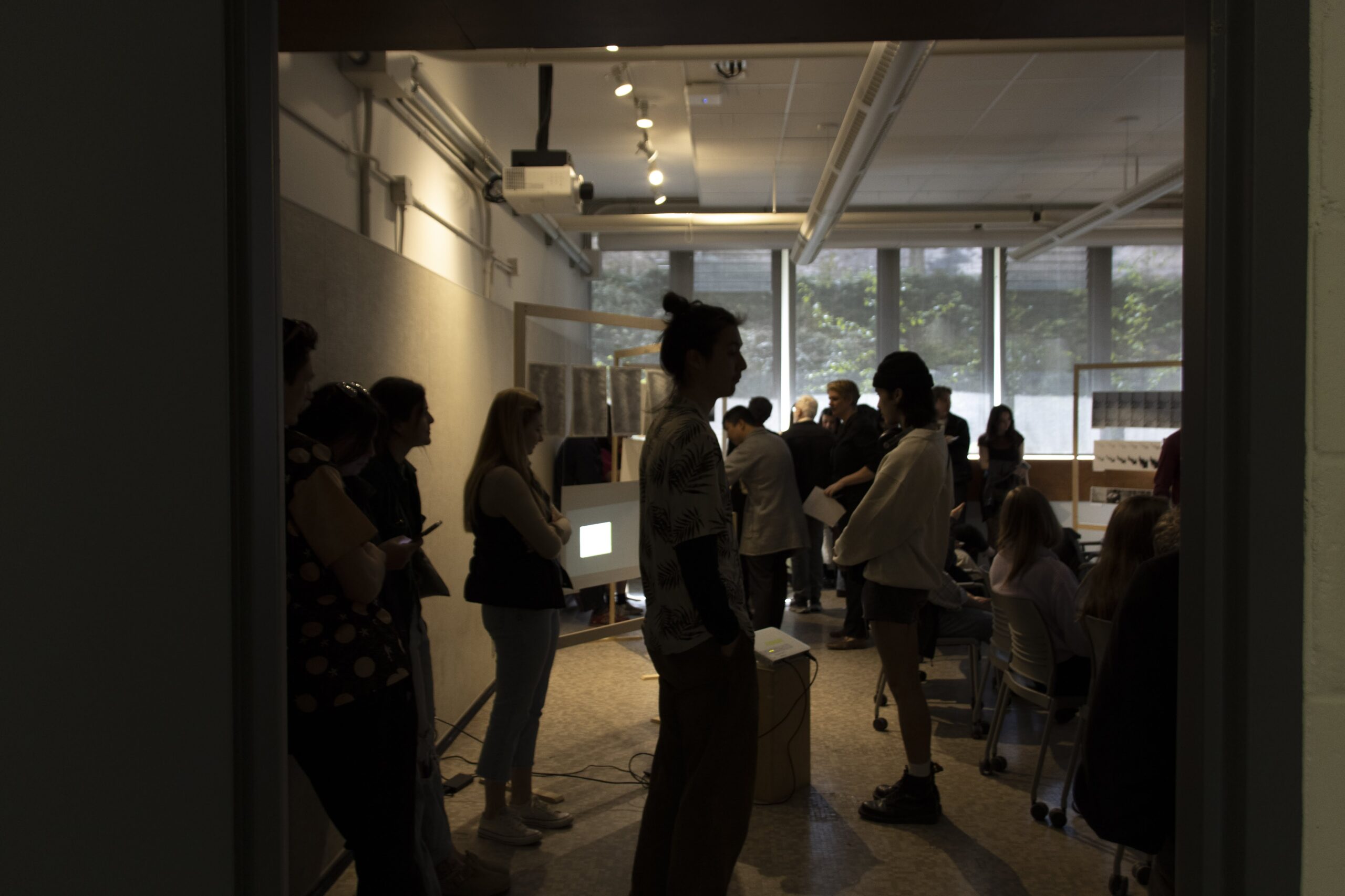 Students gathered to view a graduate project installation